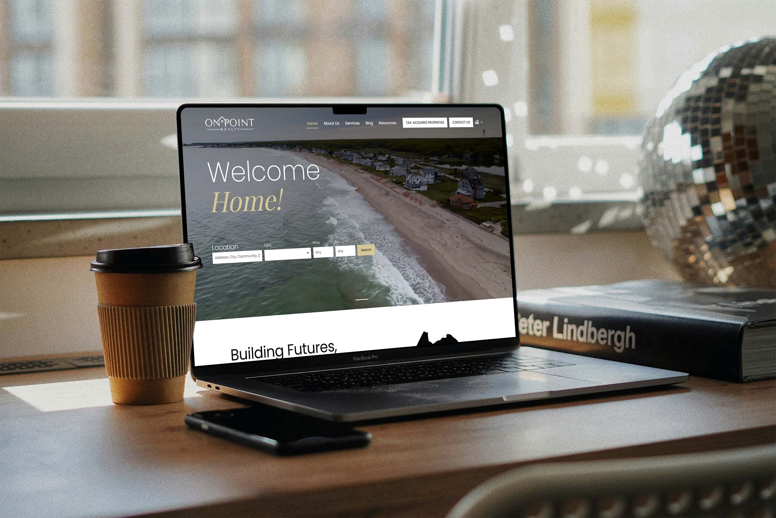 On Point Realty website displayed on a laptop showcasing a coastal real estate homepage